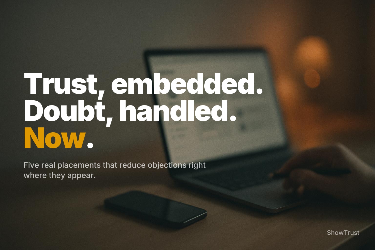 Blurred desk scene with laptop and phone UI shapes, warm amber lamp bokeh, and soft grainy tones.