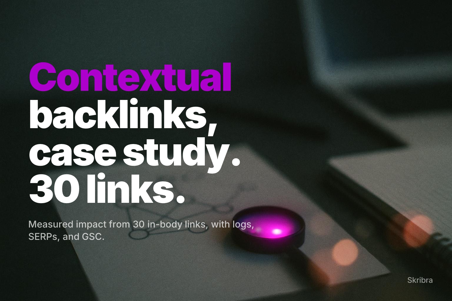 Heavily blurred desk with laptop and notebook, bokeh lights at right, and a magenta lens-like glow.